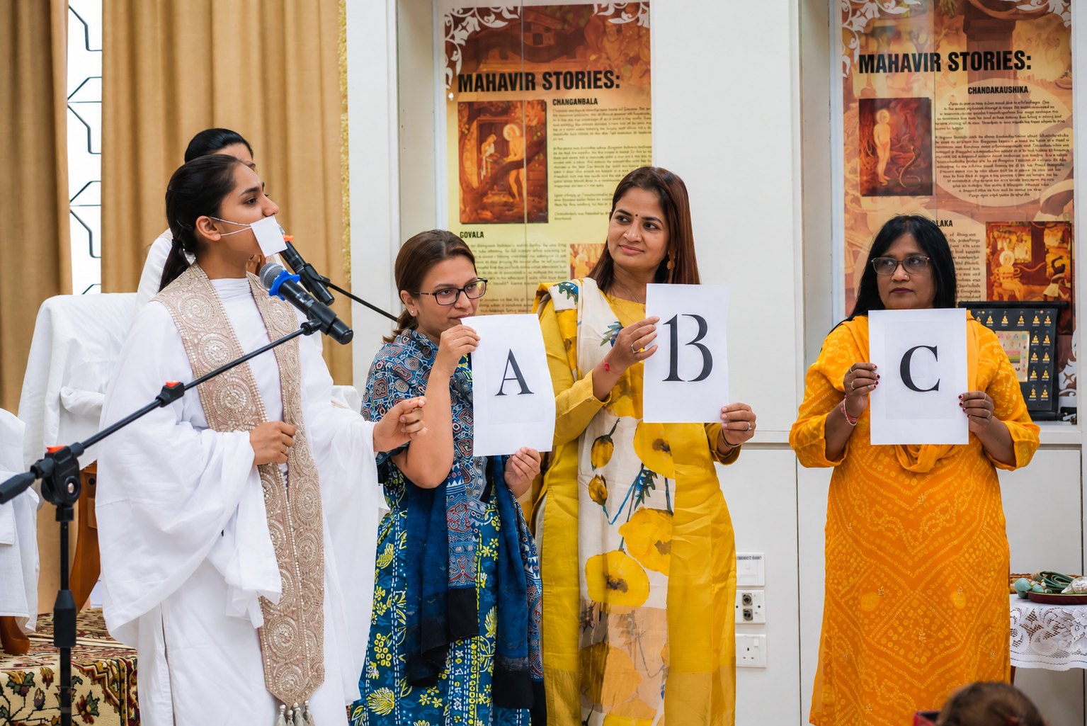 An interactive session with the sangh holding up answer cards