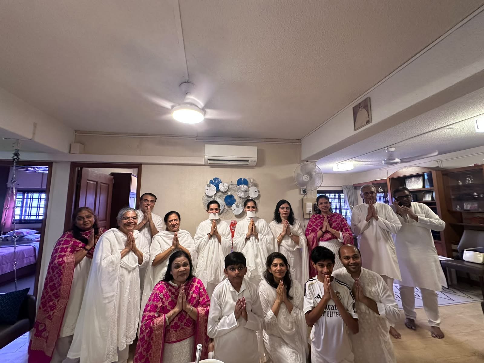 A family gathered with the mumukshus during a home visit